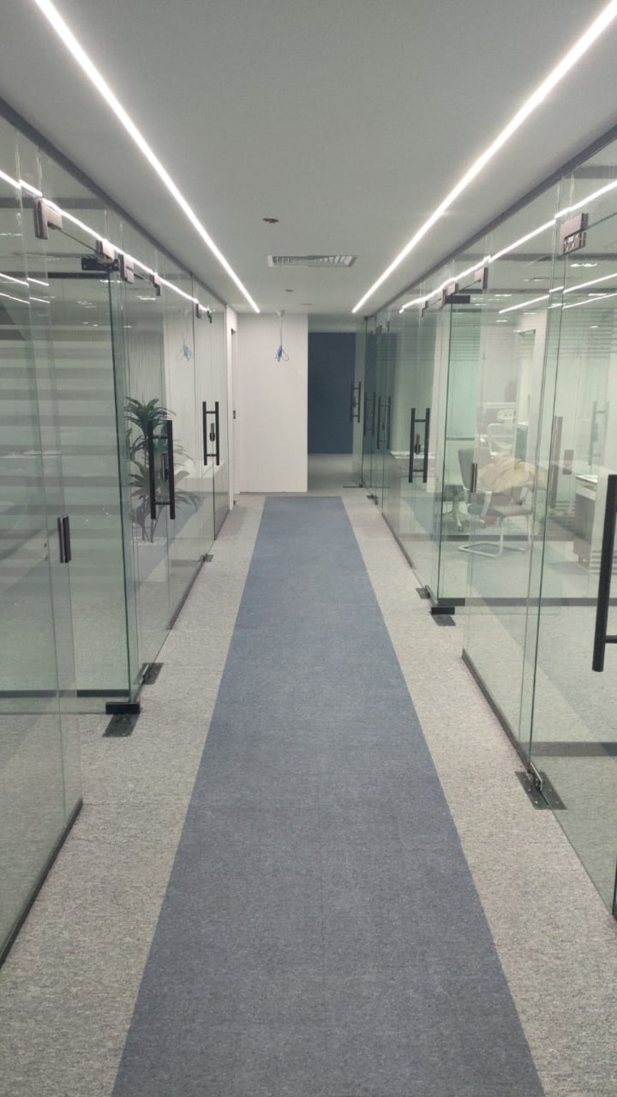 Glass office corridor with frameless doors